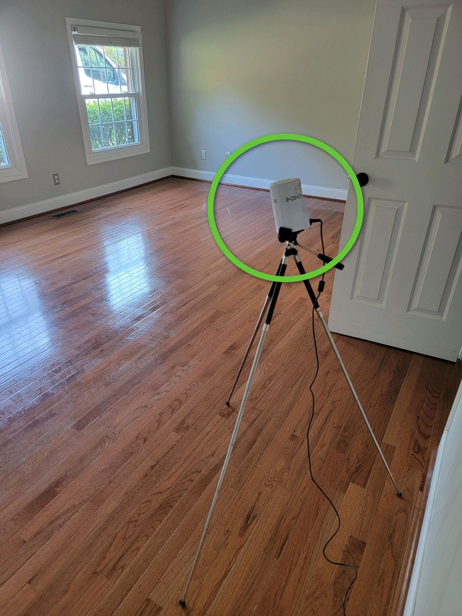 Radon testing device set up in empty room
